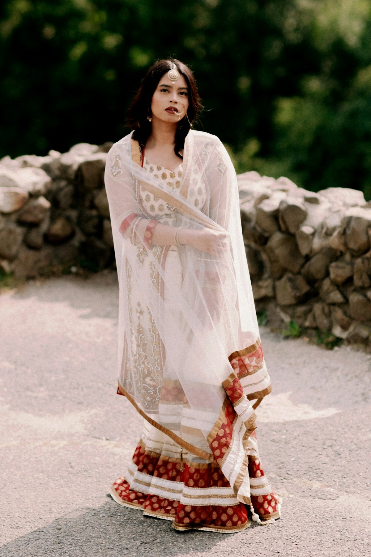 woman in white long sleeve dress standing on gray concrete pavement during daytime