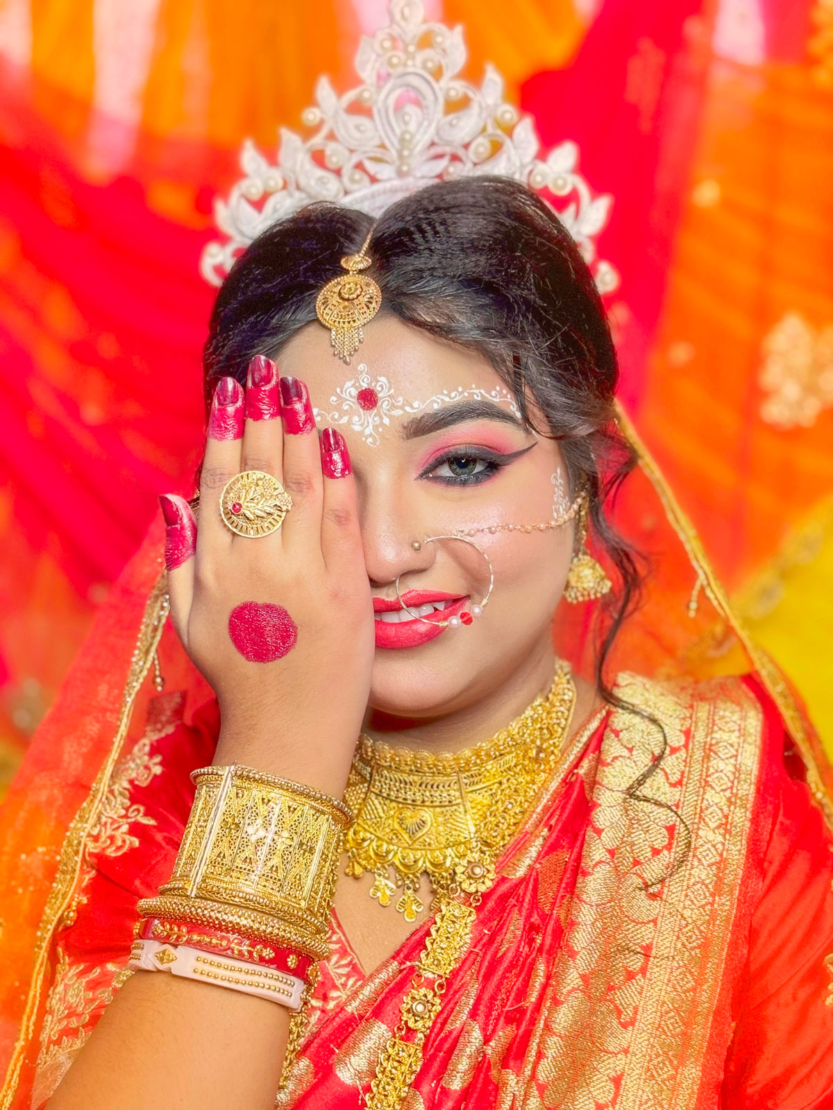 Beautiful indian bride poses with her hand.