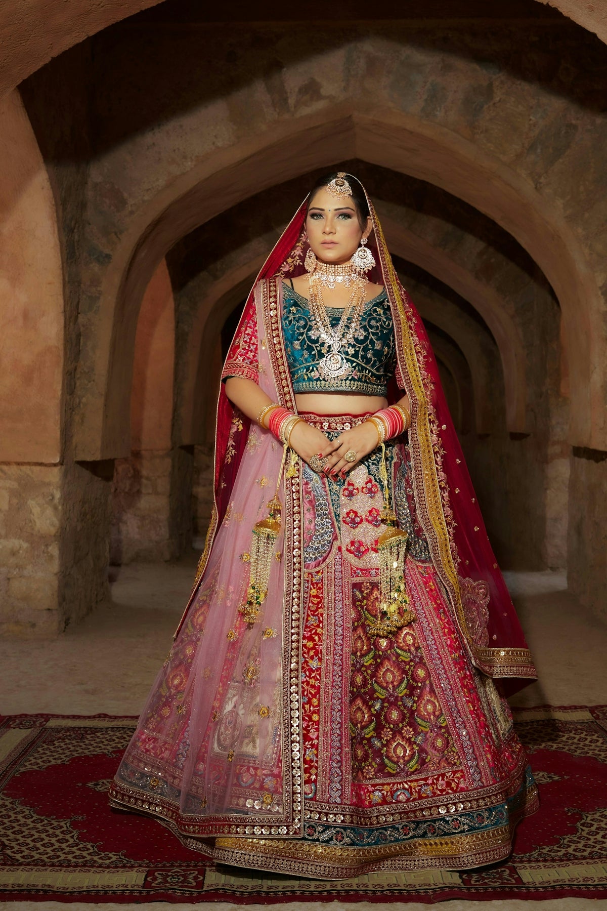 An elegantly dressed woman poses in a doorway.