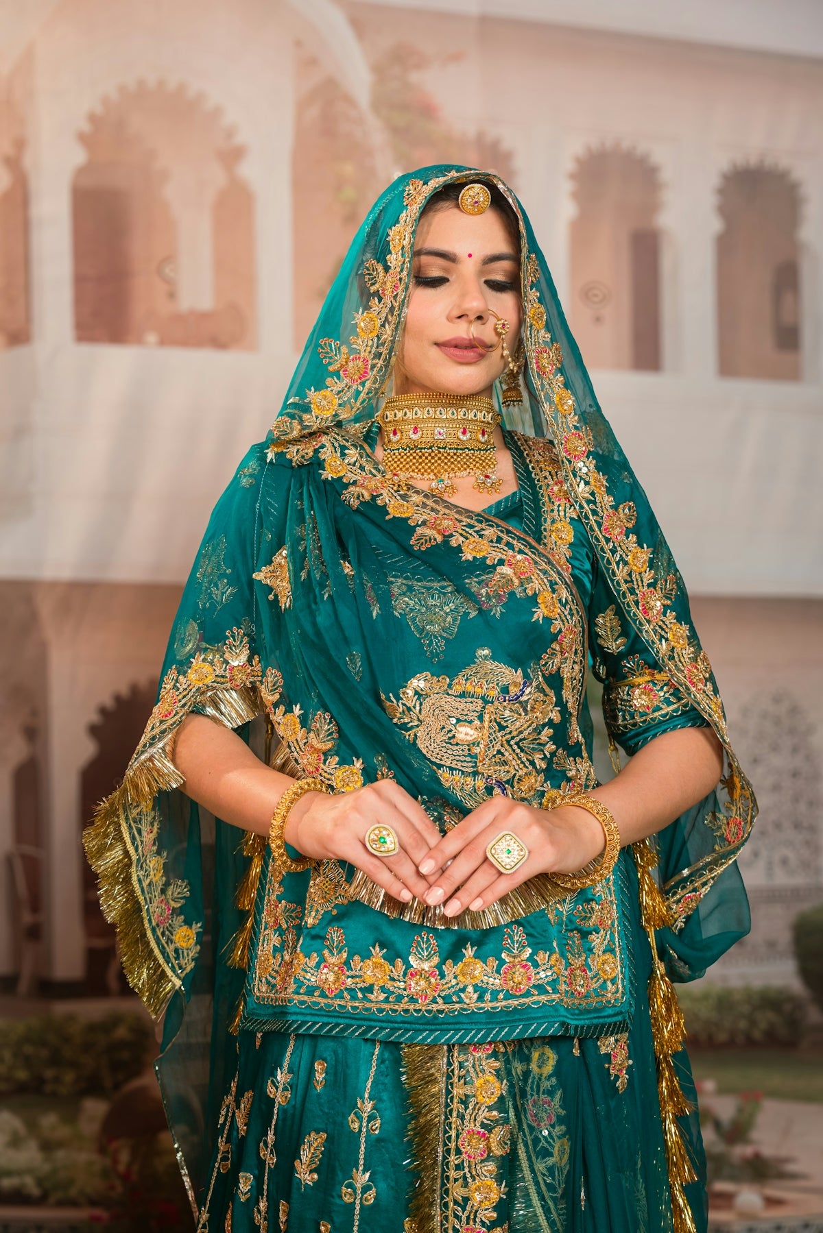 Woman in ornate teal and gold indian attire