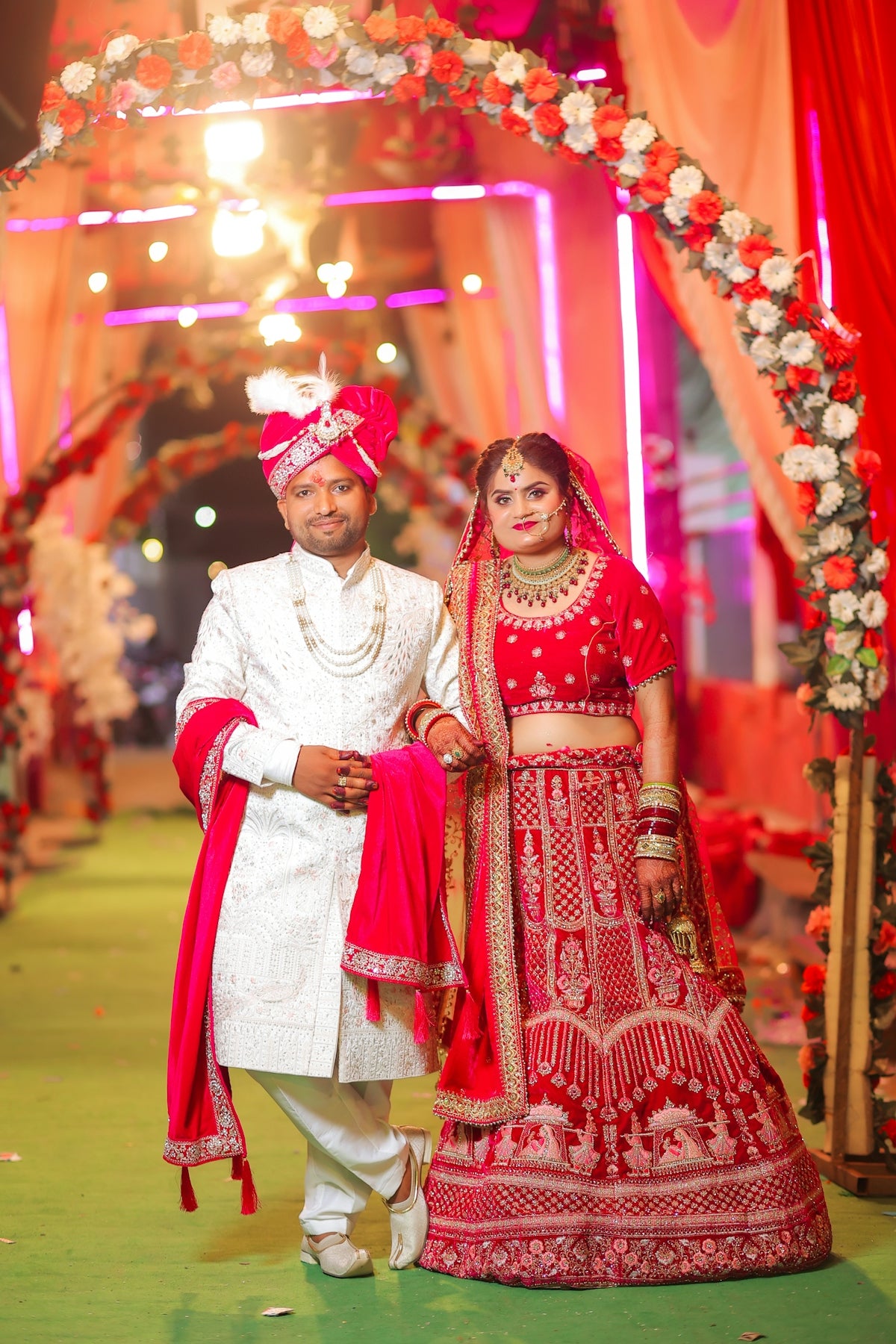 A newlywed indian couple in traditional wedding attire.