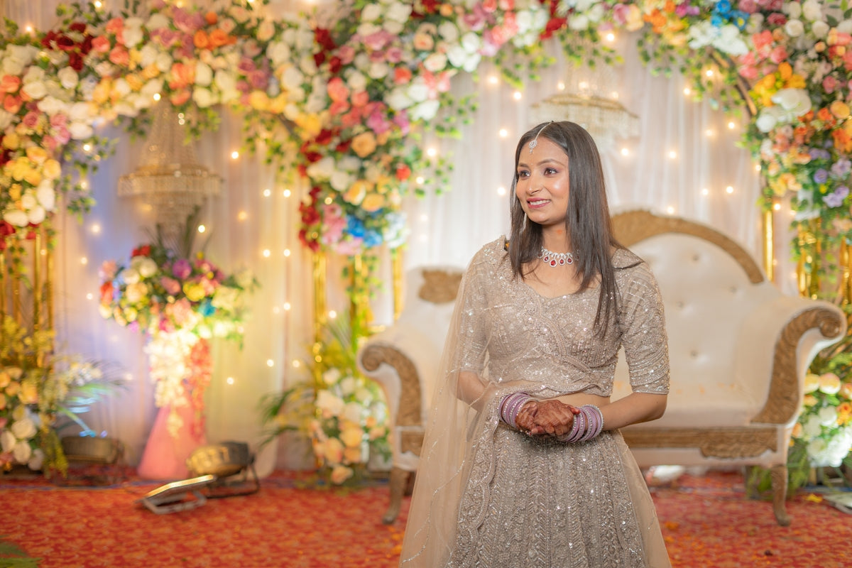 Young woman in a sparkling lehenga at a decorated event