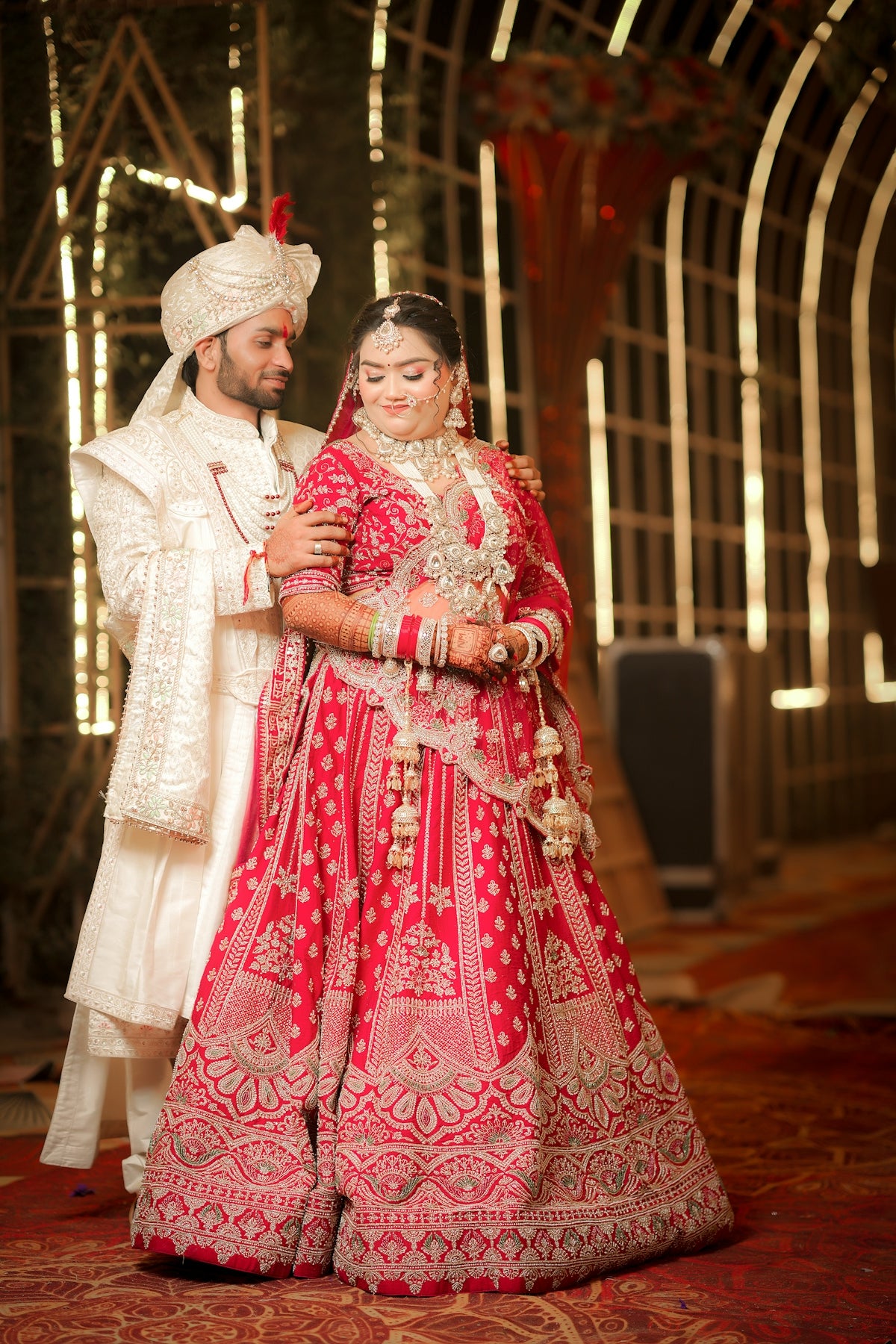 Indian bride and groom in traditional wedding attire.